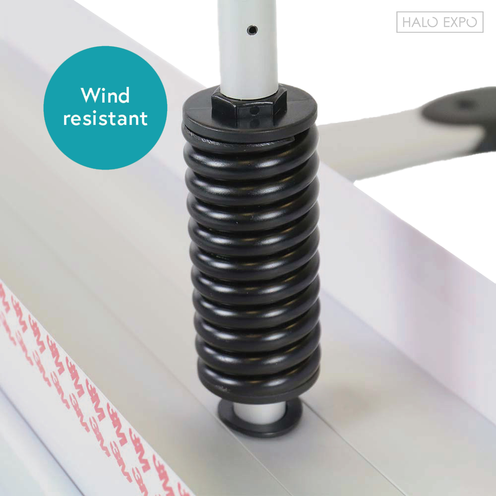 A close up of a strong spring labeled as wind resistant.
